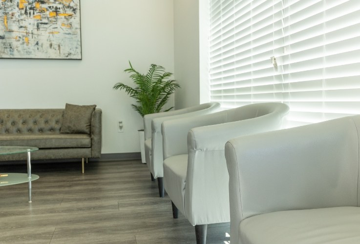 White armchairs in reception area of Denton dental office