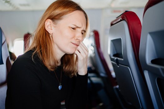 Patient in Shady Shores holding cheek in pain